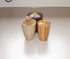 Three lidded boxes convertable to candle holders